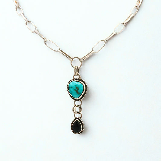 Necklace with turquoise pendant and black Onyx pendant on a white background