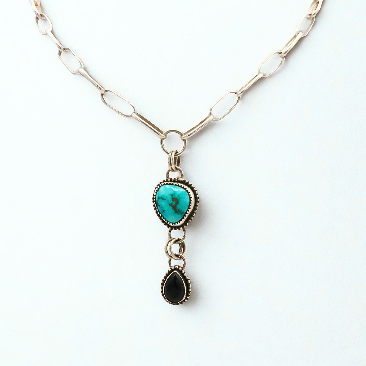 Necklace with turquoise pendant and black Onyx pendant on a white background