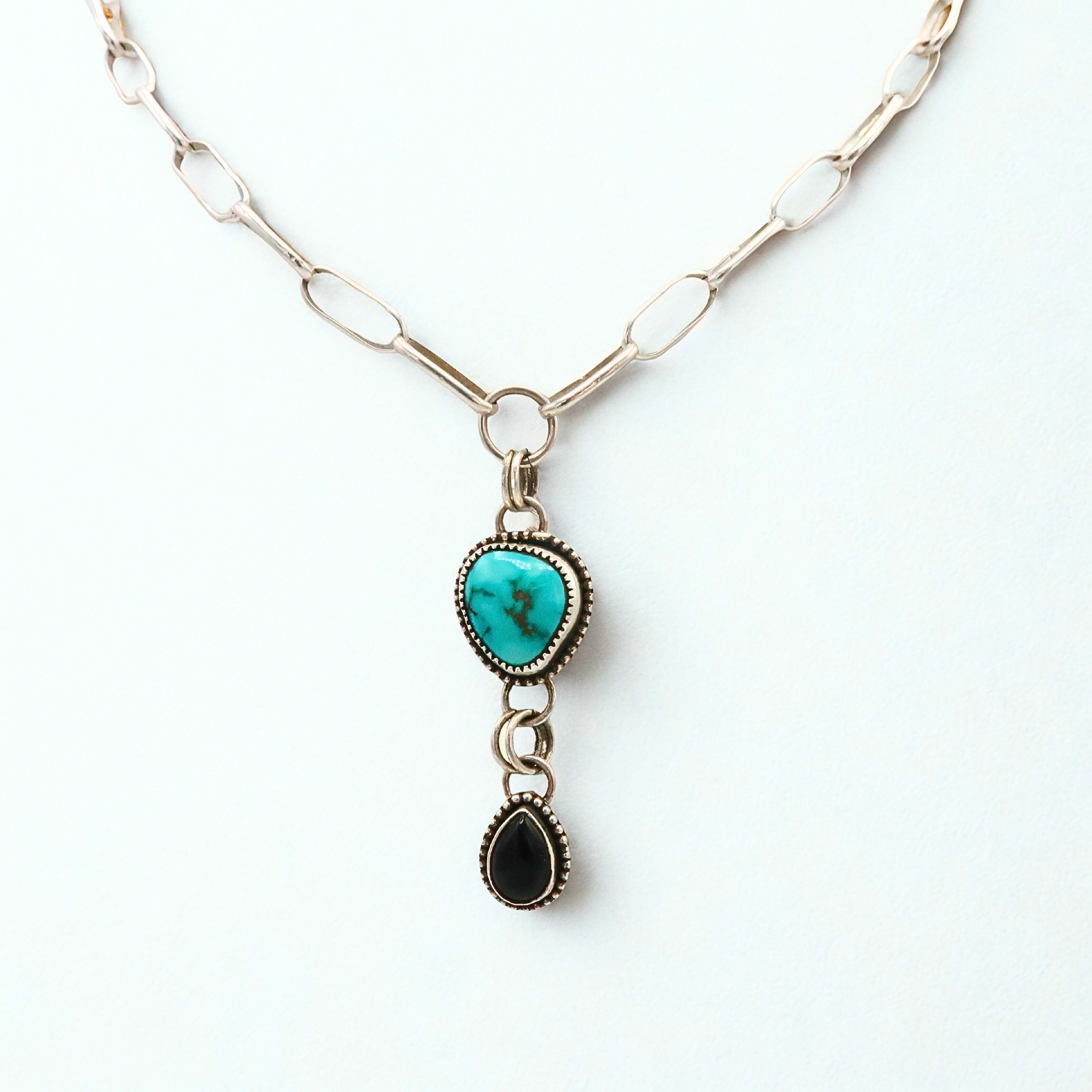 Necklace with turquoise pendant and black Onyx pendant on a white background