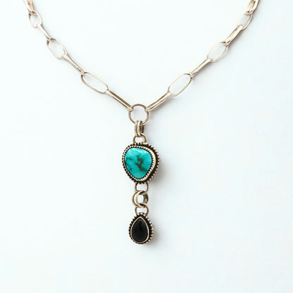 Necklace with turquoise pendant and black Onyx pendant on a white background